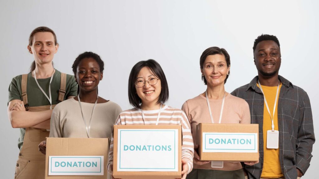 Volunteers Holding Boxes Containing Donations Charity 1024x576